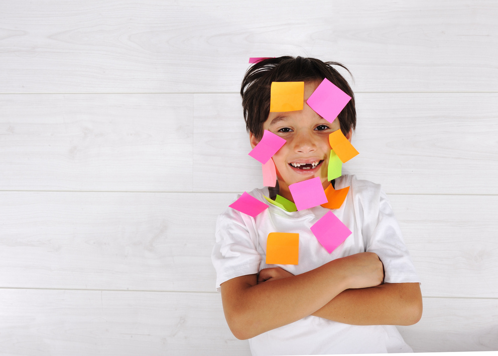 Little boy with memo posts on his face